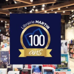 interieur de la librairie avec des livres en rayons et sur table avec un logo Librairie Martin 100 ans
